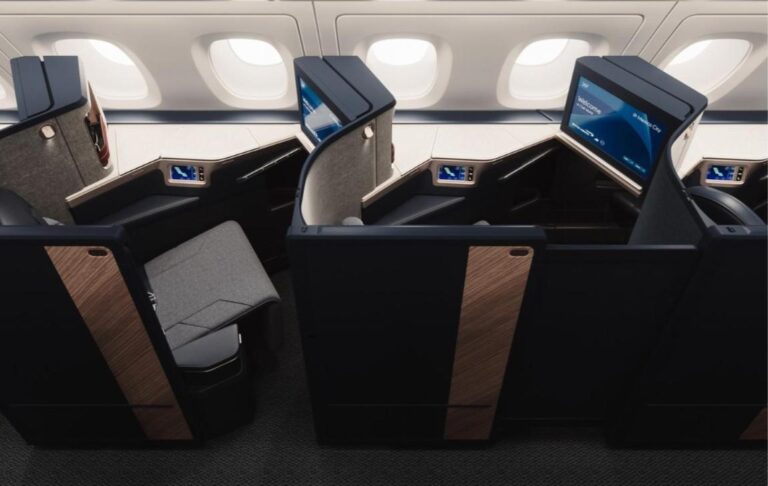 British Airways Finally Shows Its New A380: 12 First Suites, a 106-Seat Club Suite Deck and a Bollinger Upgrade From 1 October Refreshed Club Suite seats on the British Airways A380 upper deck with navy shells, wood-effect door panels and grey upholstery
