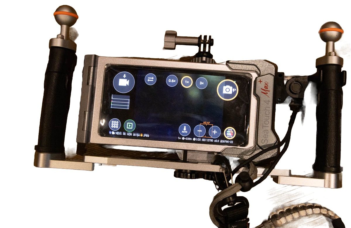 Back of the DIVEVOLK SeaTouch 4 Max Platinum V2 housing showing the phone touchscreen with the underwater camera app controls visible through the gel membrane