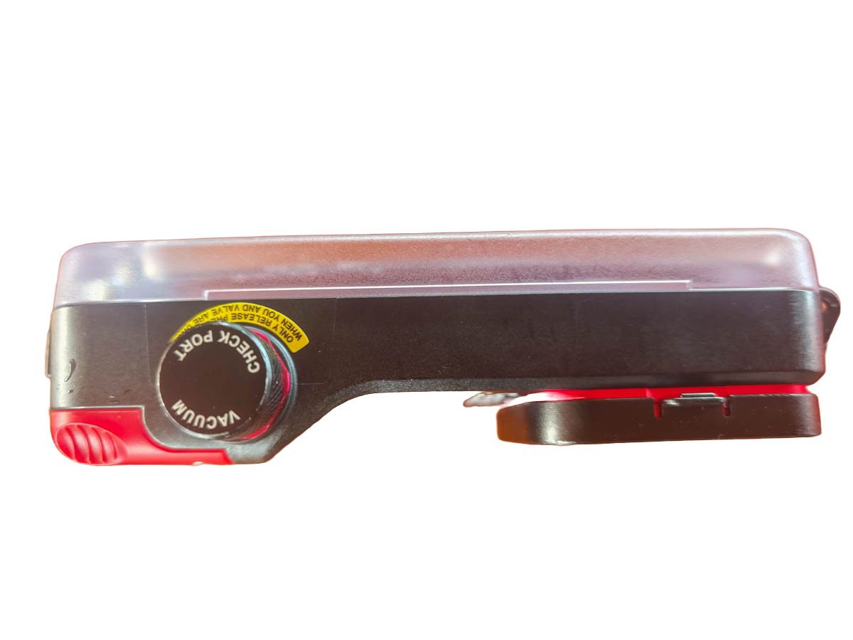 Side profile of the SeaLife SportDiver Ultra housing showing the slim polycarbonate shell, the yellow-labeled vacuum check port cap and the red lever controls