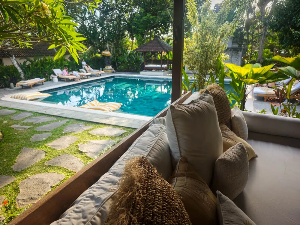 Main swimming pool at Goddess Retreat Ubud with loungers, stepping stones and tropical garden