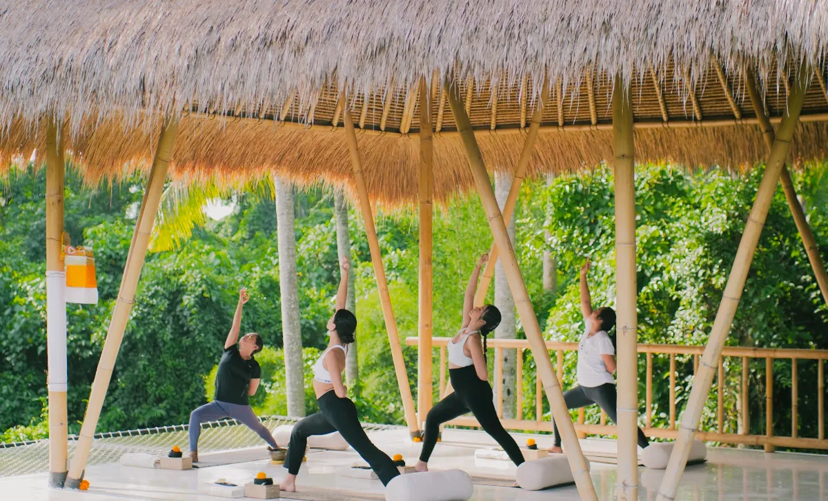 Yoga class in the open-sided bamboo shala surrounded by jungle at Goddess Retreat Ubud