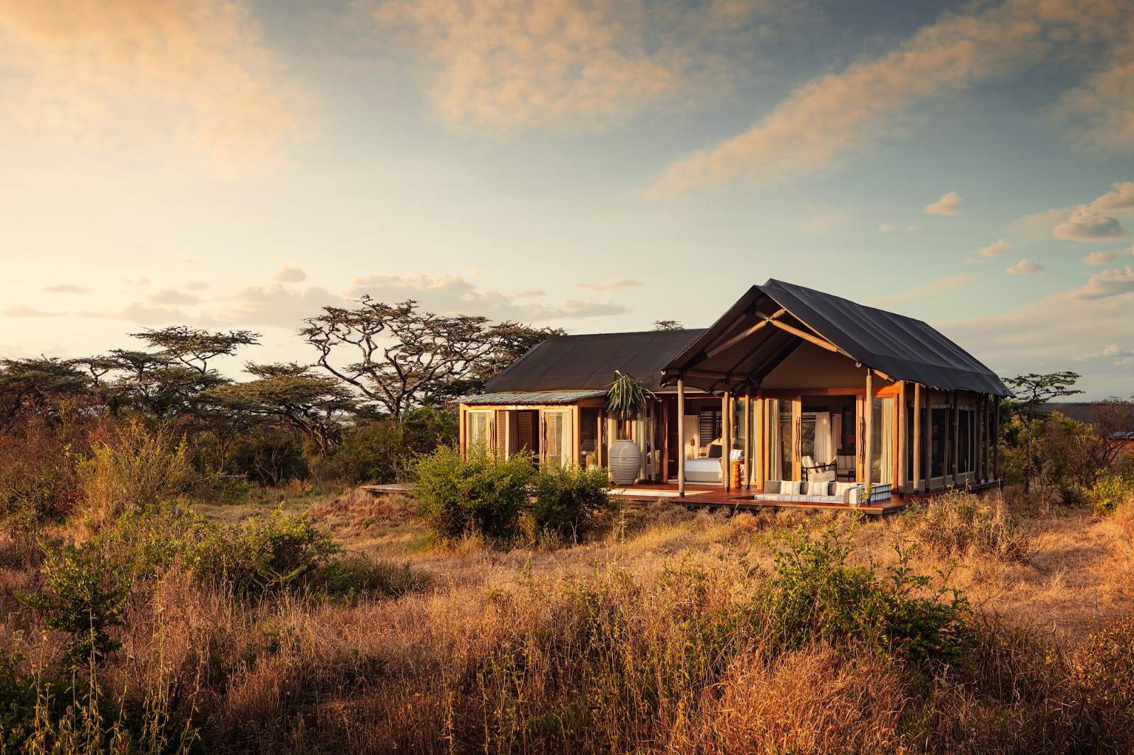 Tented suite exterior at sunset at JW Marriott Mount Kenya Rhino Reserve Safari Camp, Solio, Laikipia