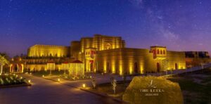 The Leela Jaisalmer resort lit at night under a starry desert sky, Rajasthan