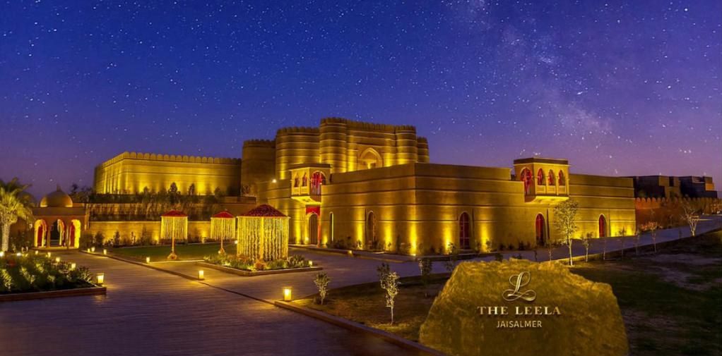The Leela Jaisalmer resort lit at night under a starry desert sky, Rajasthan