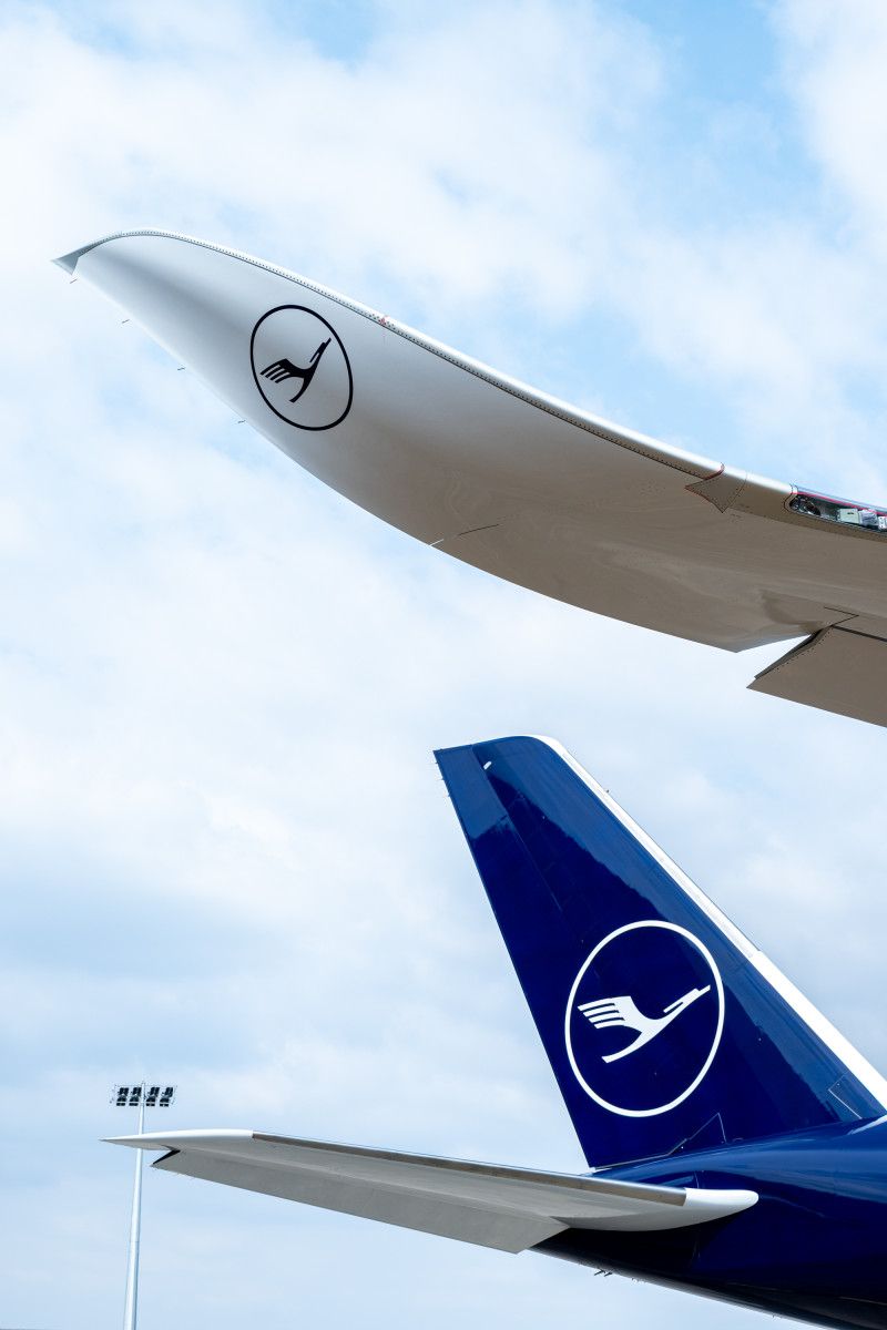 Tail of the Lufthansa A350-1000 with the crane logo, seen from below beside the wing