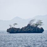 Karst islet in Misool under a hazy sky