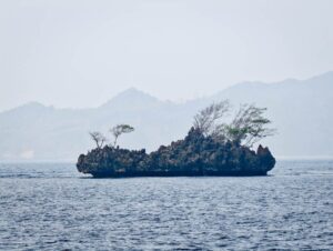 Karst islet in Misool under a hazy sky