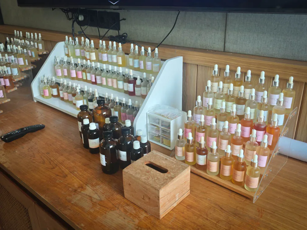 Rows of essential oil and fragrance bottles on a perfumer's organ at a perfume-making workshop in Bali