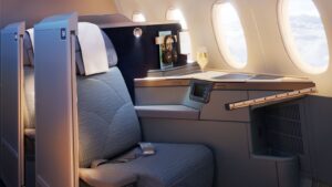 Rendering of a Philippine Airlines A350-1000 Business Class suite with its sliding privacy door open, flat-bed seat, screen and storage
