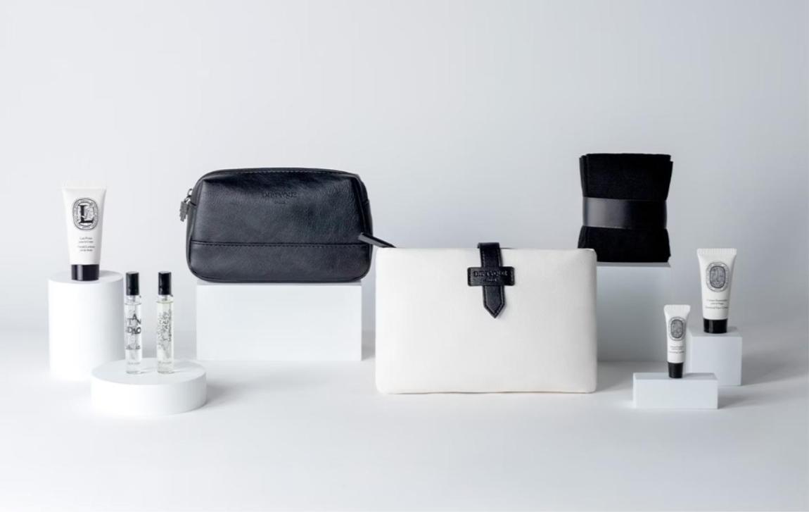 Qatar Airways Diptyque amenity kits in black and white leather with body lotion, lip balm, face mist and fragrance vials