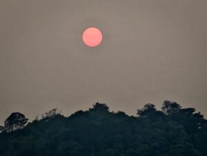 Red sun through forest-fire smoke, October 2026