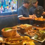 Chefs serving the Asian Street Market night on Scubaspa Zen