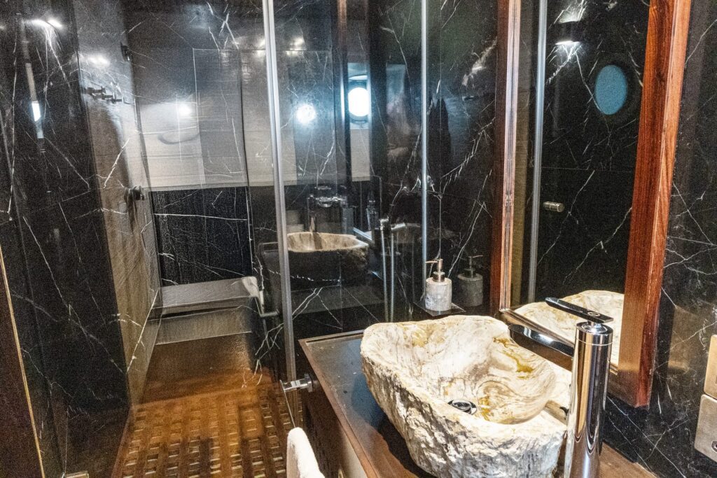 Shower and stone basin in a Scubaspa Zen bathroom