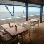 Dining tables on the main deck of Scubaspa Zen