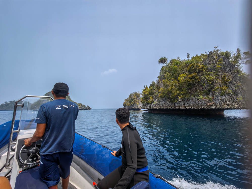 Snorkel guide driving the Scubaspa Zen speedboat towards the karst islands of Misool