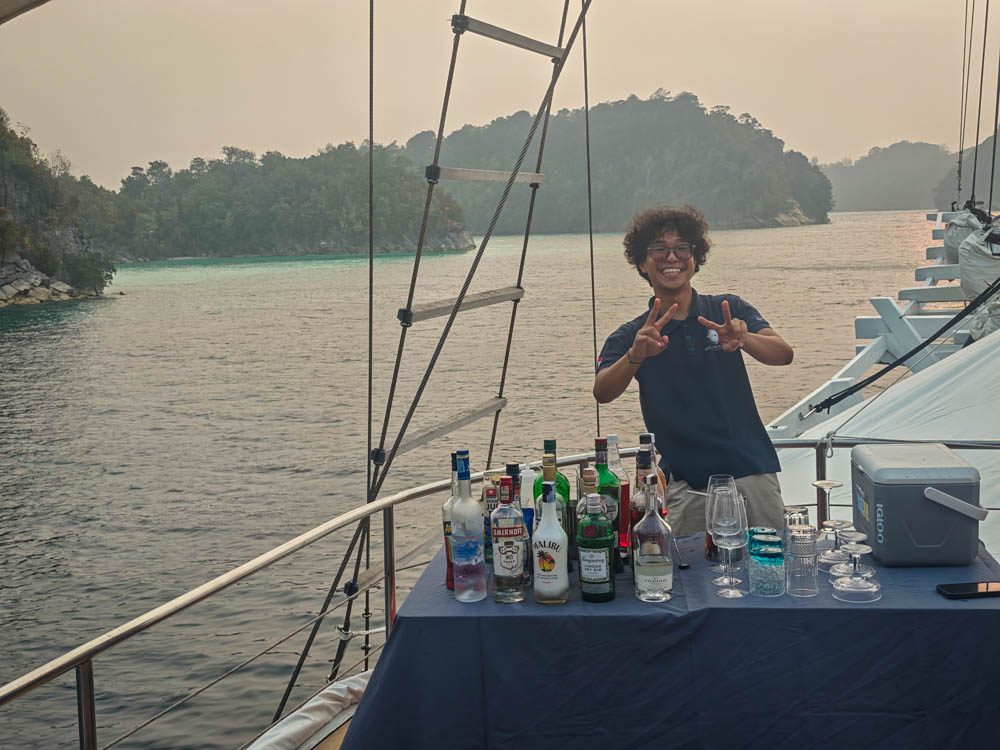 Barman setting up a sunset bar on the deck of Scubaspa Zen in Misool
