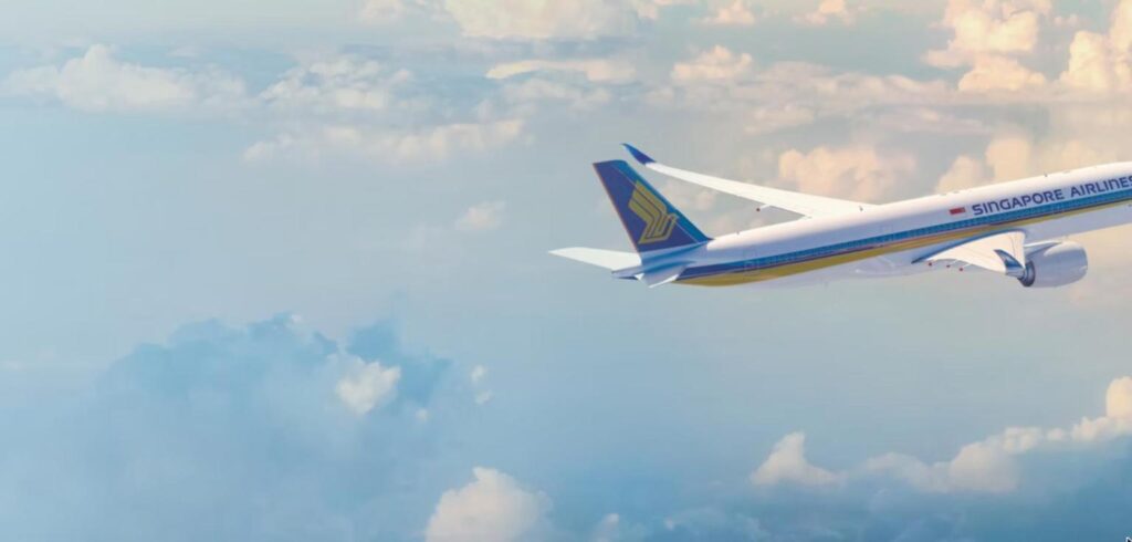 Singapore Airlines Airbus A350-900 in flight above the clouds, showing the blue tail and gold bird logo