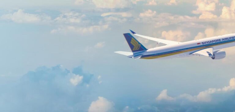 Singapore Airlines Airbus A350-900 in flight above the clouds, showing the blue tail and gold bird logo