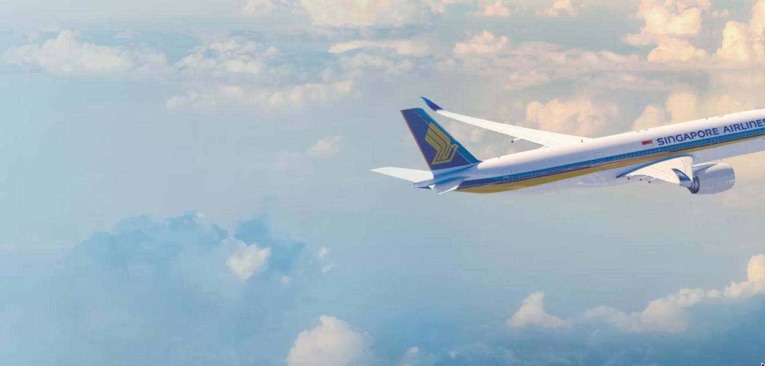 Singapore Airlines Airbus A350-900 in flight above the clouds, showing the blue tail and gold bird logo