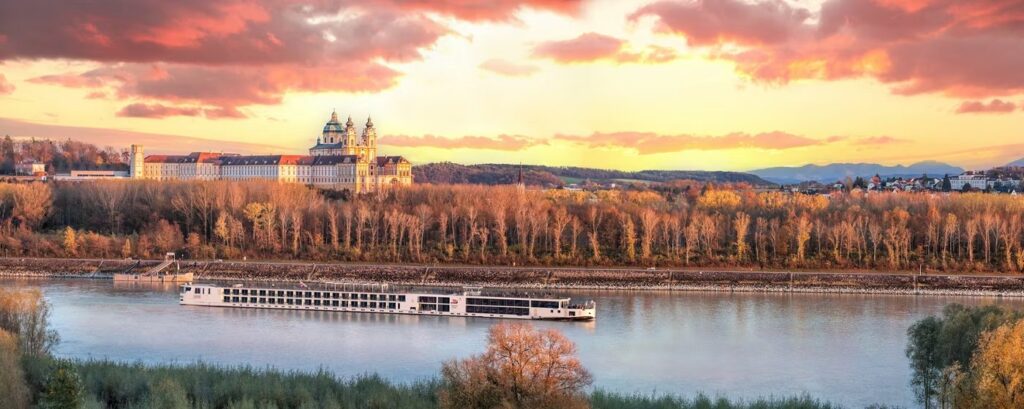 A Viking Longship on the Danube below Melk Abbey at sunset, the class of ship Viking Haki, Halogi, Sjofn and Rota belong to