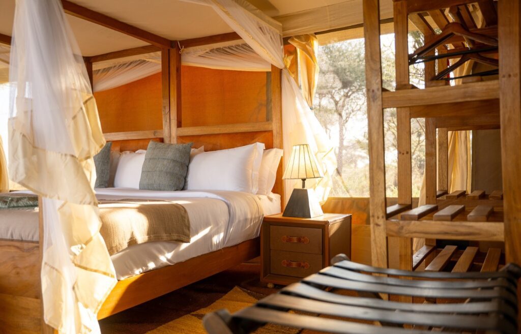 Guest tent interior with emperor bed at Wild Wakati Camp