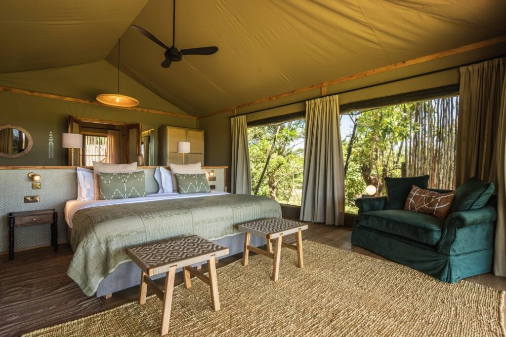 Bedroom inside a tented suite at Wilderness Mara, Masai Mara